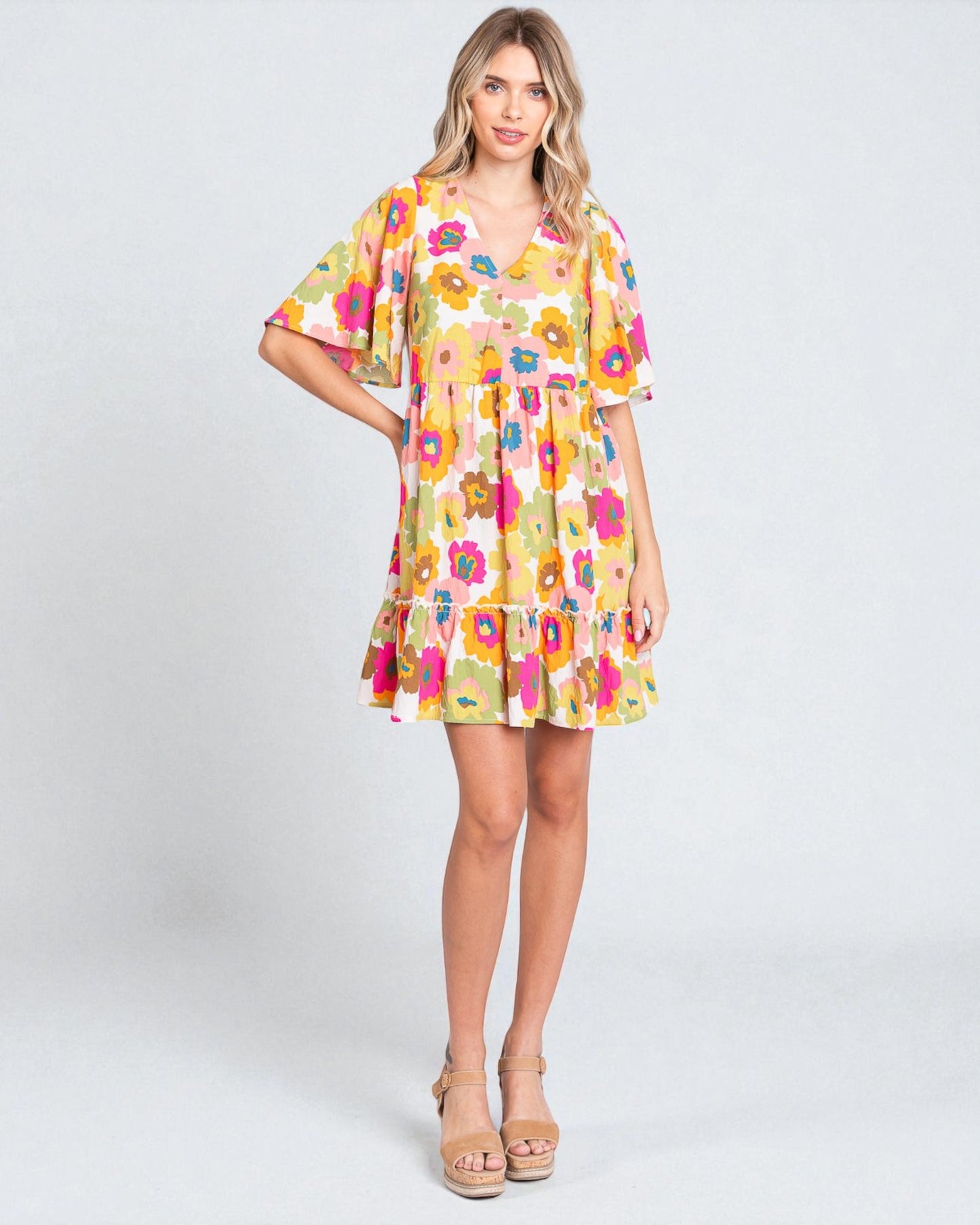 Woman wearing a colorful floral dress on a white background