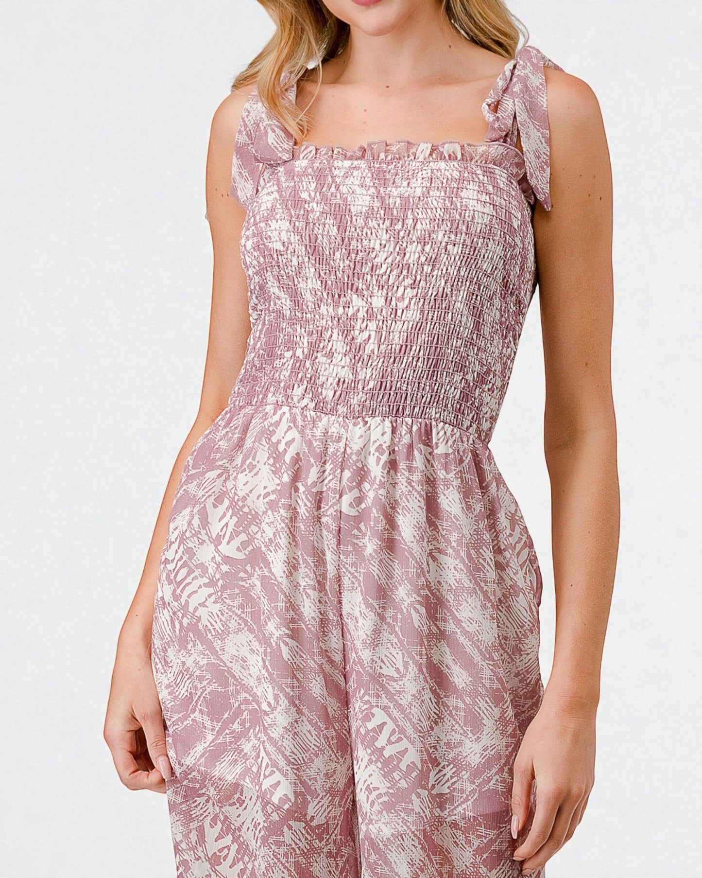 Woman wearing a pink floral dress on a white background