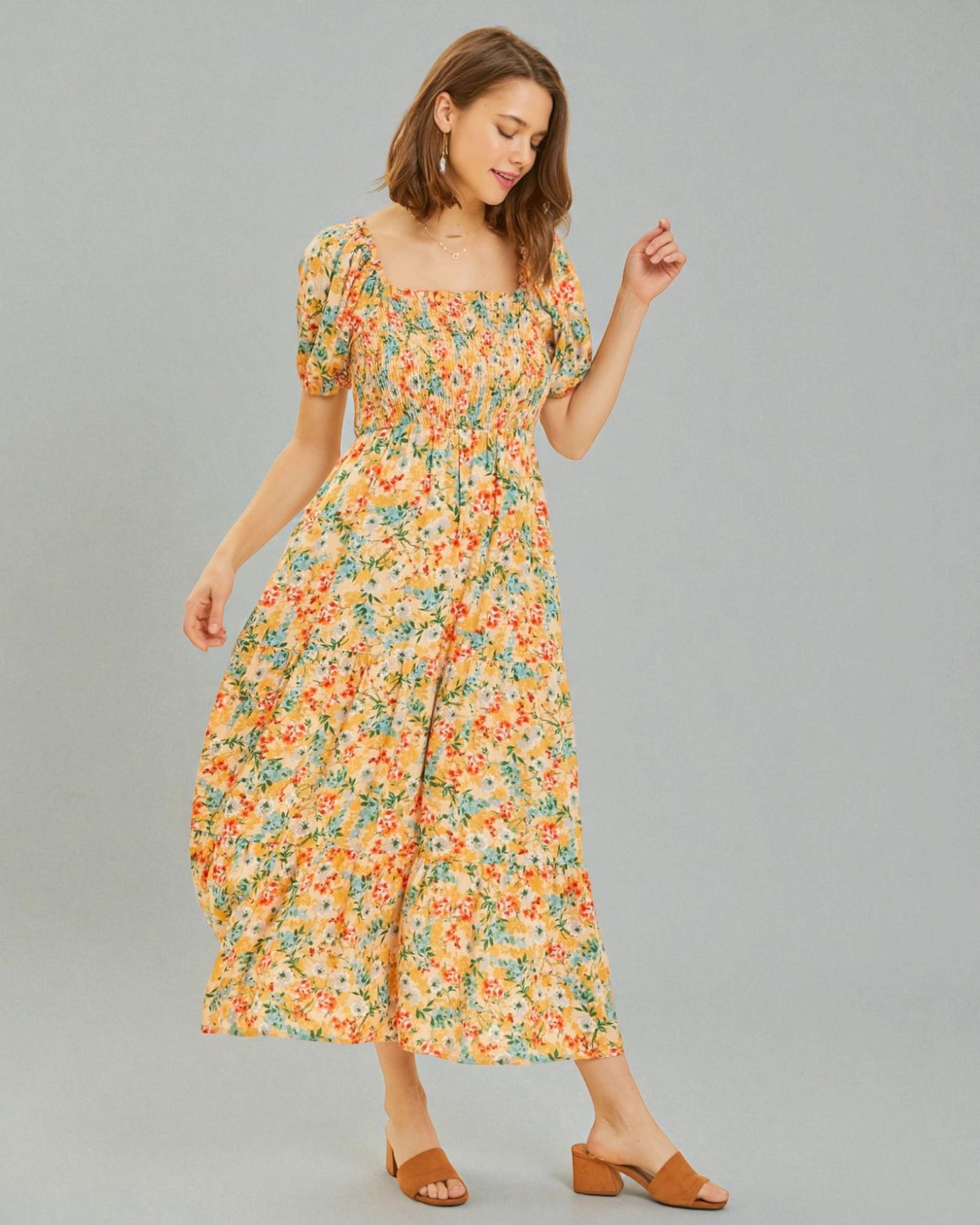 Woman wearing a floral dress on a gray background