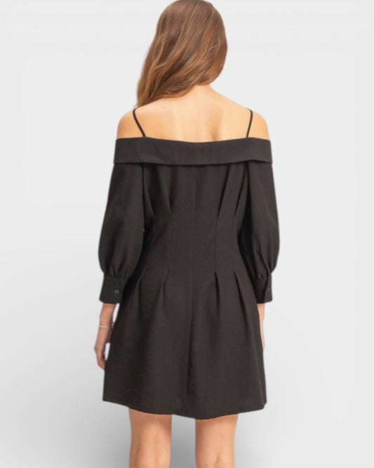 Black off-shoulder dress worn by a person on a white background
