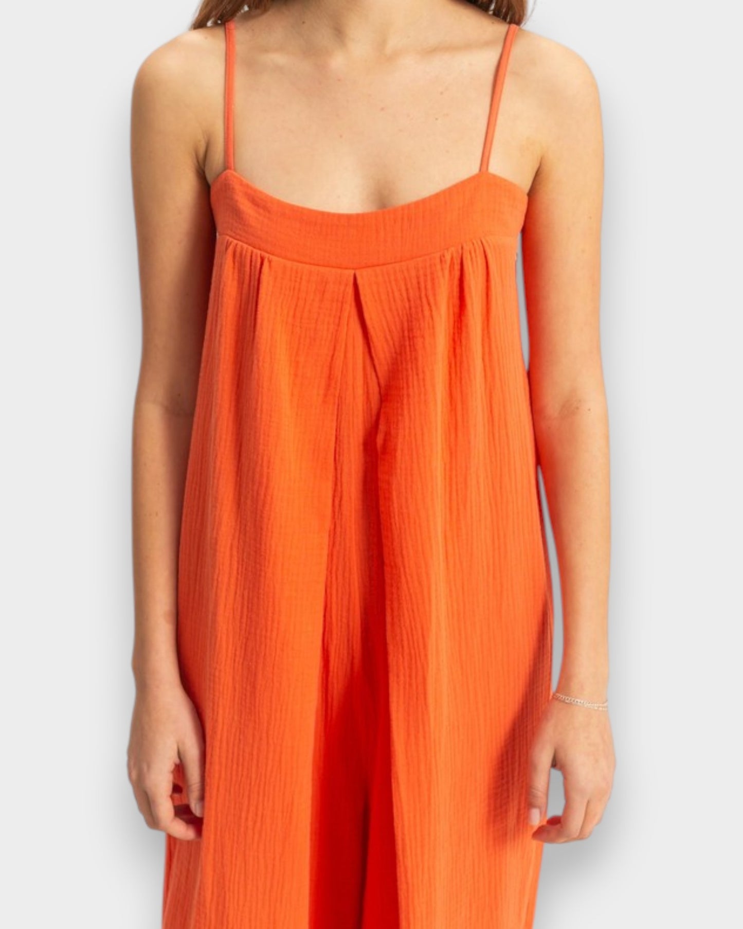 Orange dress worn by a person on a white background