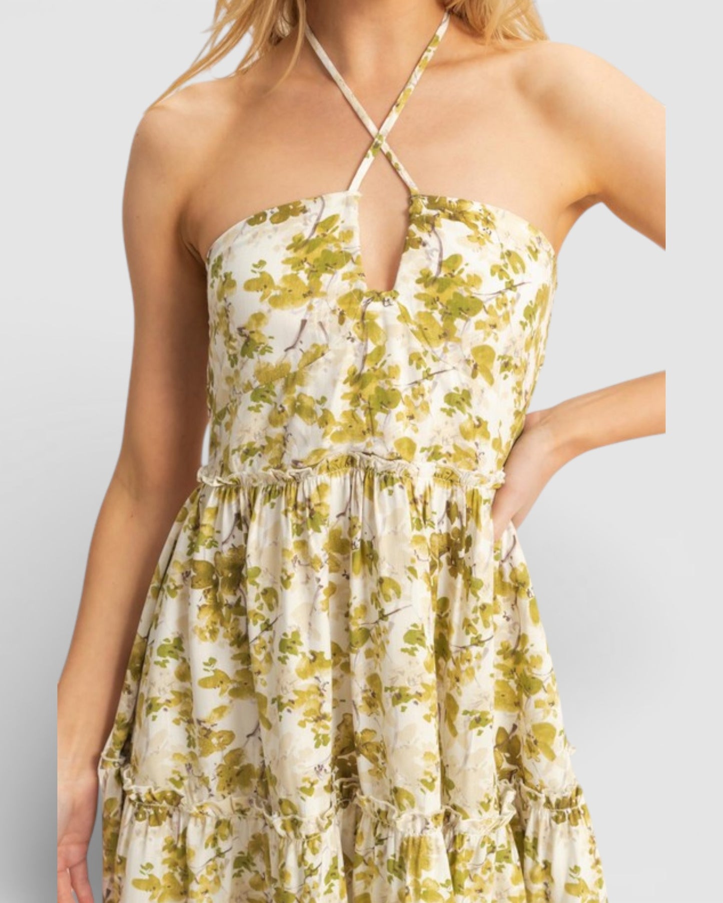 Woman wearing a floral dress with a plain background