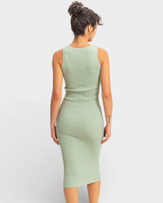 Woman wearing a light green ribbed dress on a white background