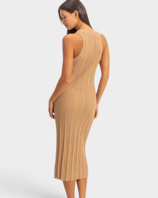 Woman wearing a beige ribbed dress on a white background
