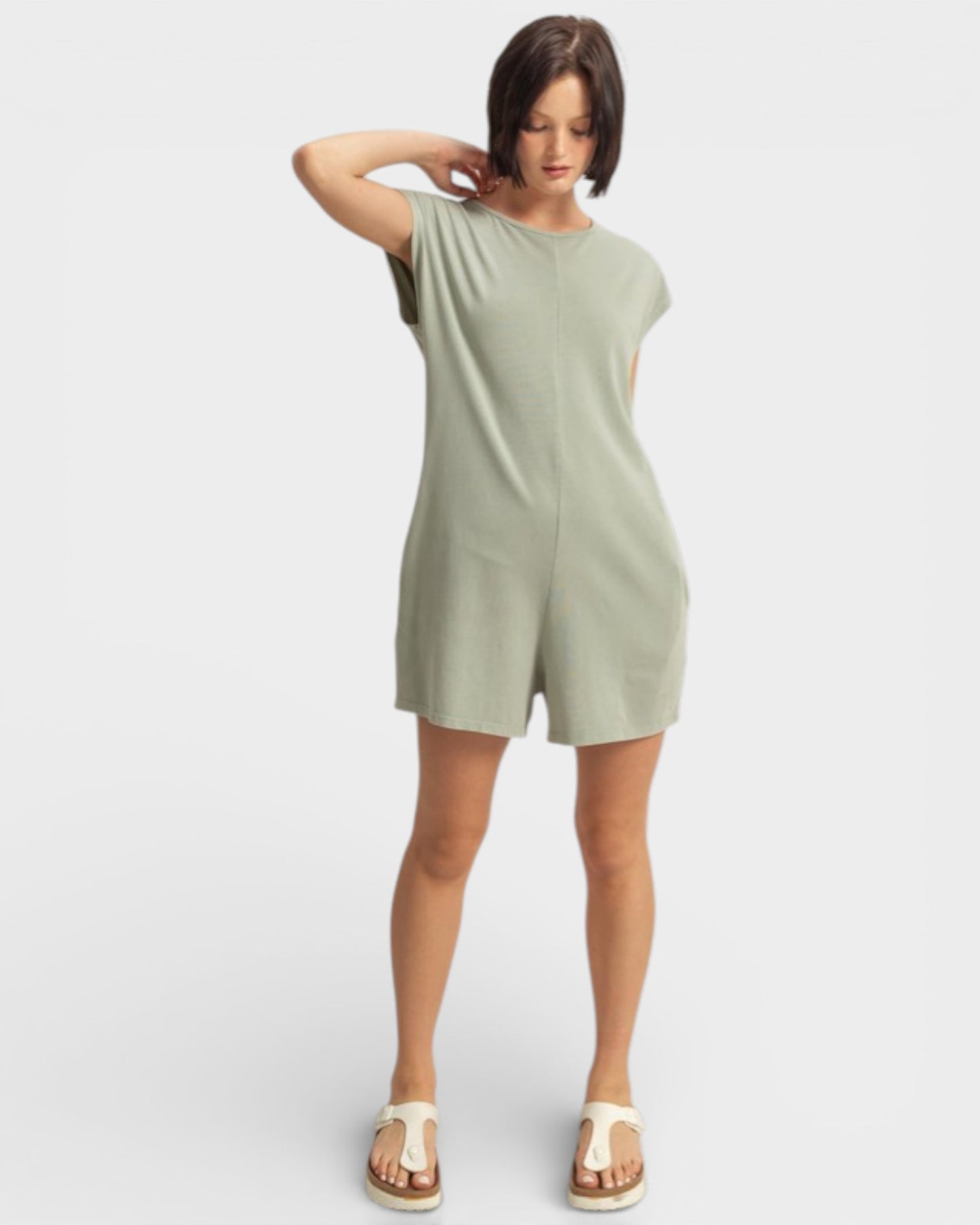 Woman wearing a green dress on a white background