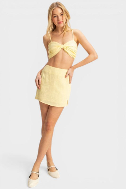 Woman wearing a yellow bikini set on a white background