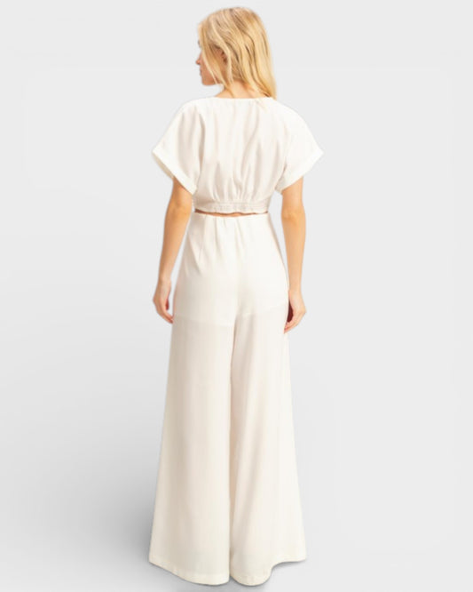 Woman wearing a white dress against a plain background