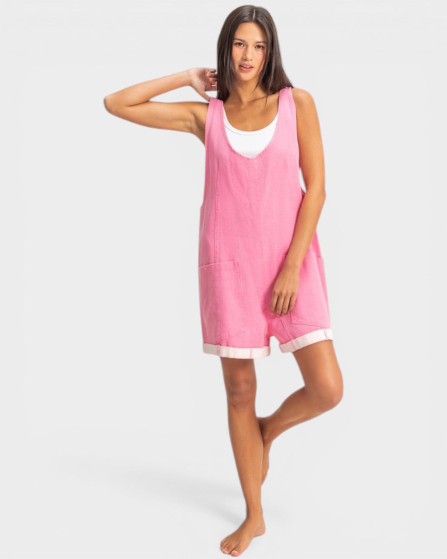 Woman wearing a pink sleeveless dress on a white background