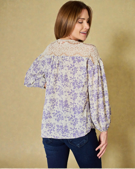 Woman wearing a floral blouse with a beige background