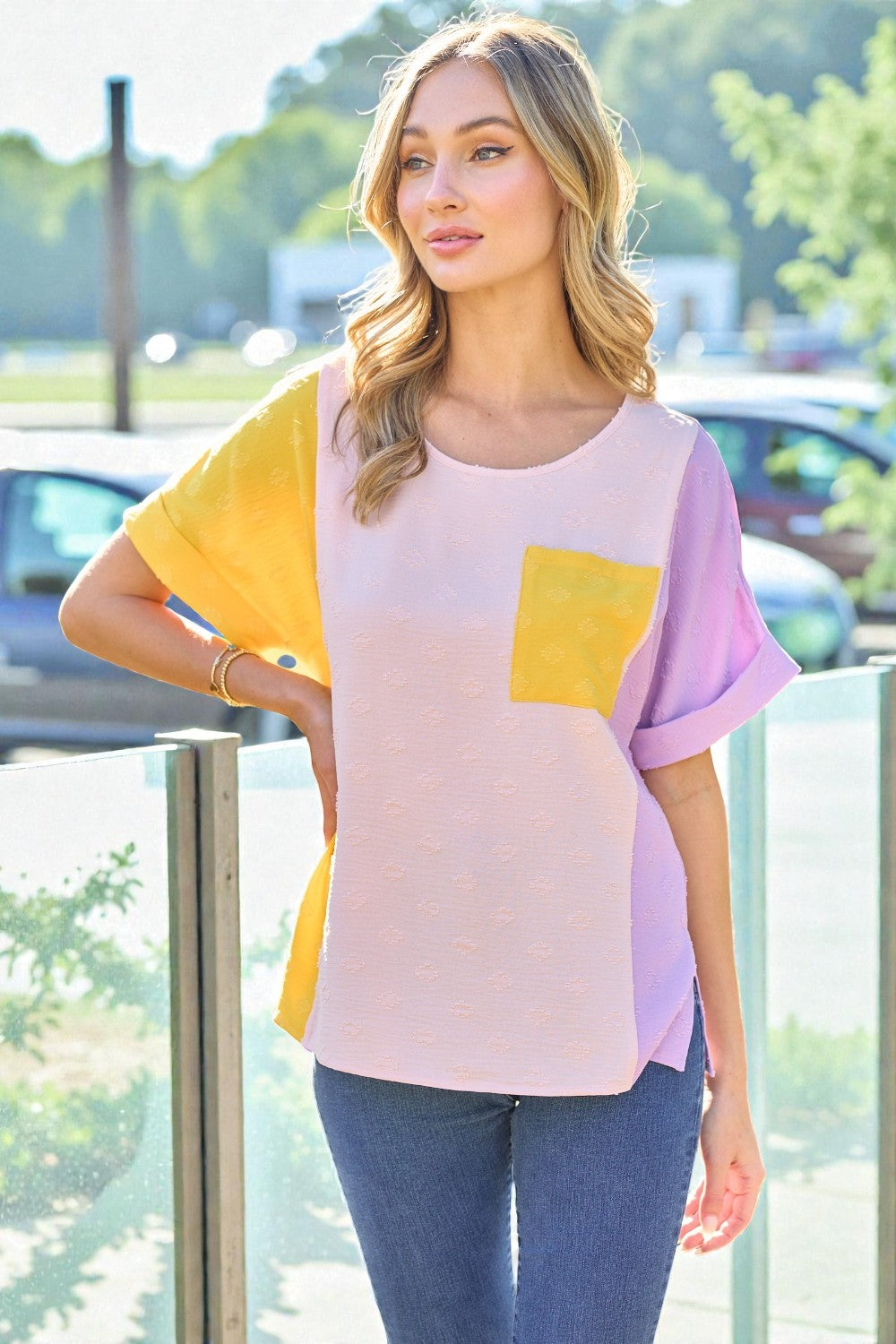 Woman wearing a colorful shirt with a blurred outdoor background