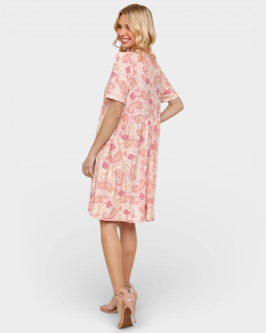 Woman wearing a pink floral dress on a white background