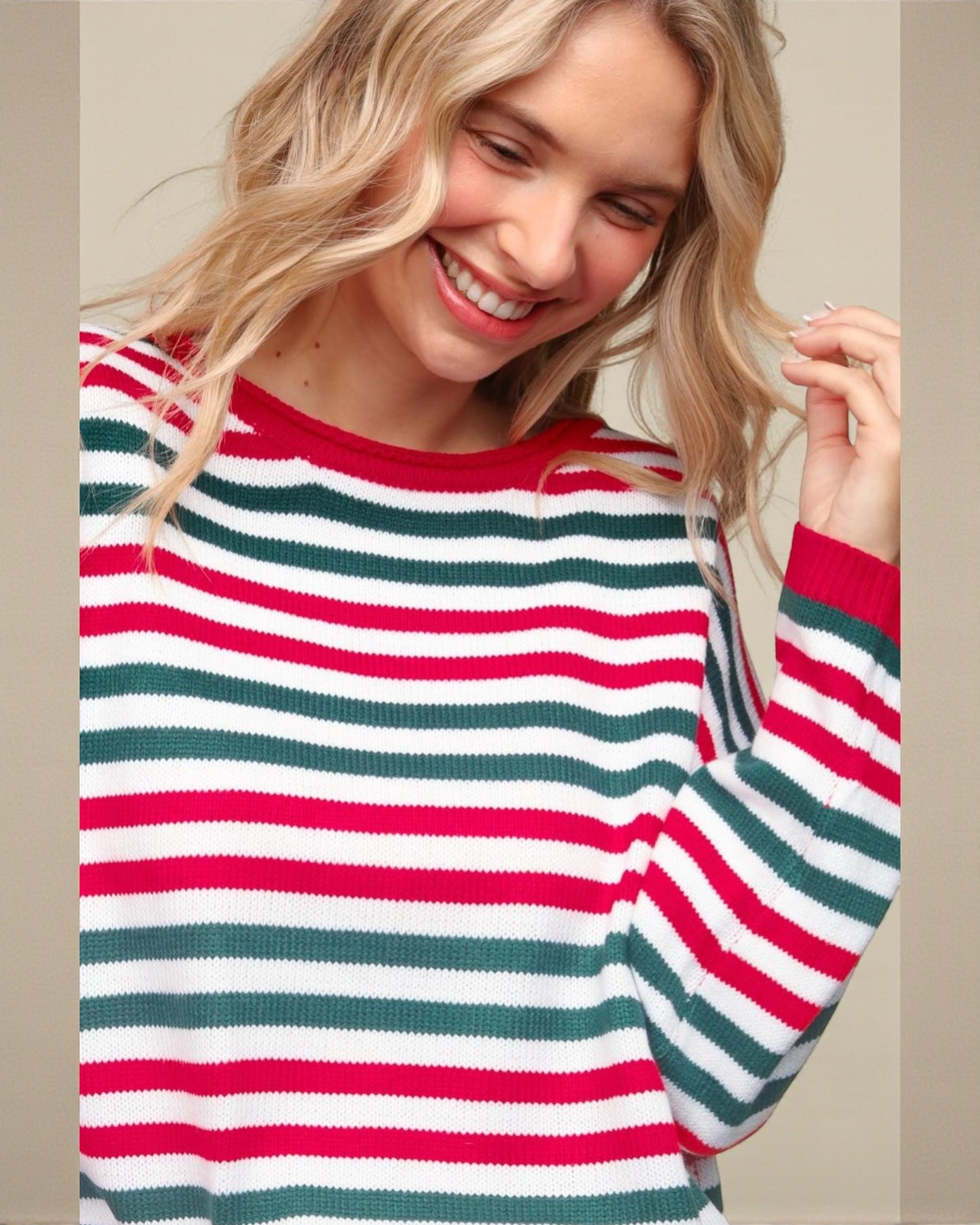 Woman wearing a red, green, and white striped sweater