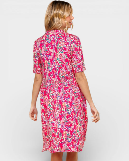 Woman wearing a pink floral dress on a white background