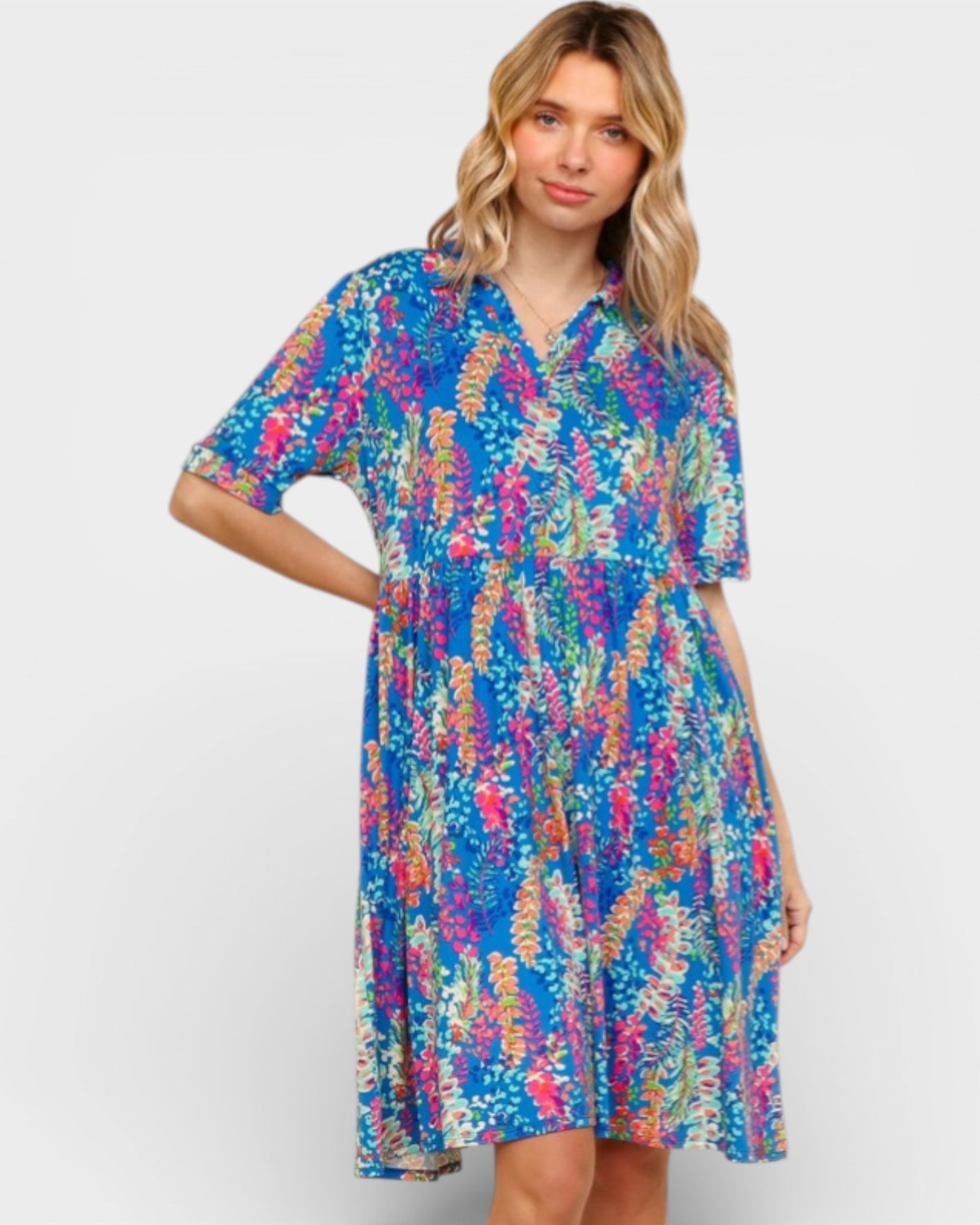 Woman wearing a colorful patterned dress on a white background