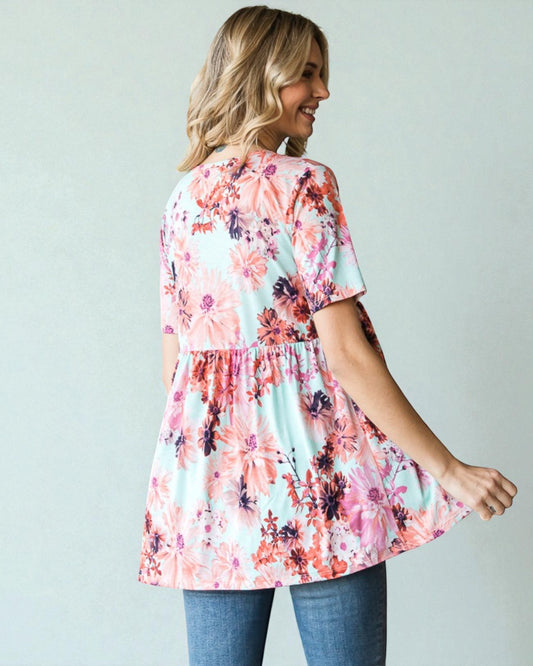 Woman wearing a floral dress with a plain background