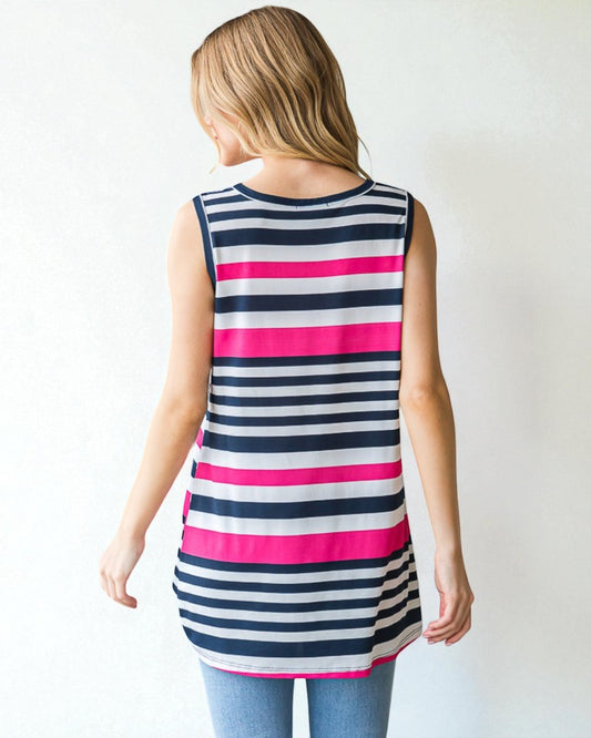 Woman wearing a sleeveless striped shirt with pink and navy horizontal stripes on a plain background
