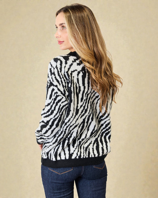 Woman wearing a zebra print sweater against a beige background