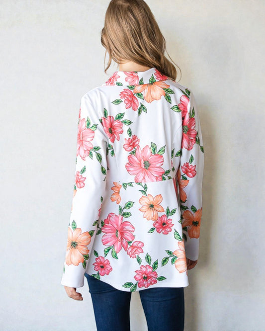 Woman wearing a floral blouse with a plain background