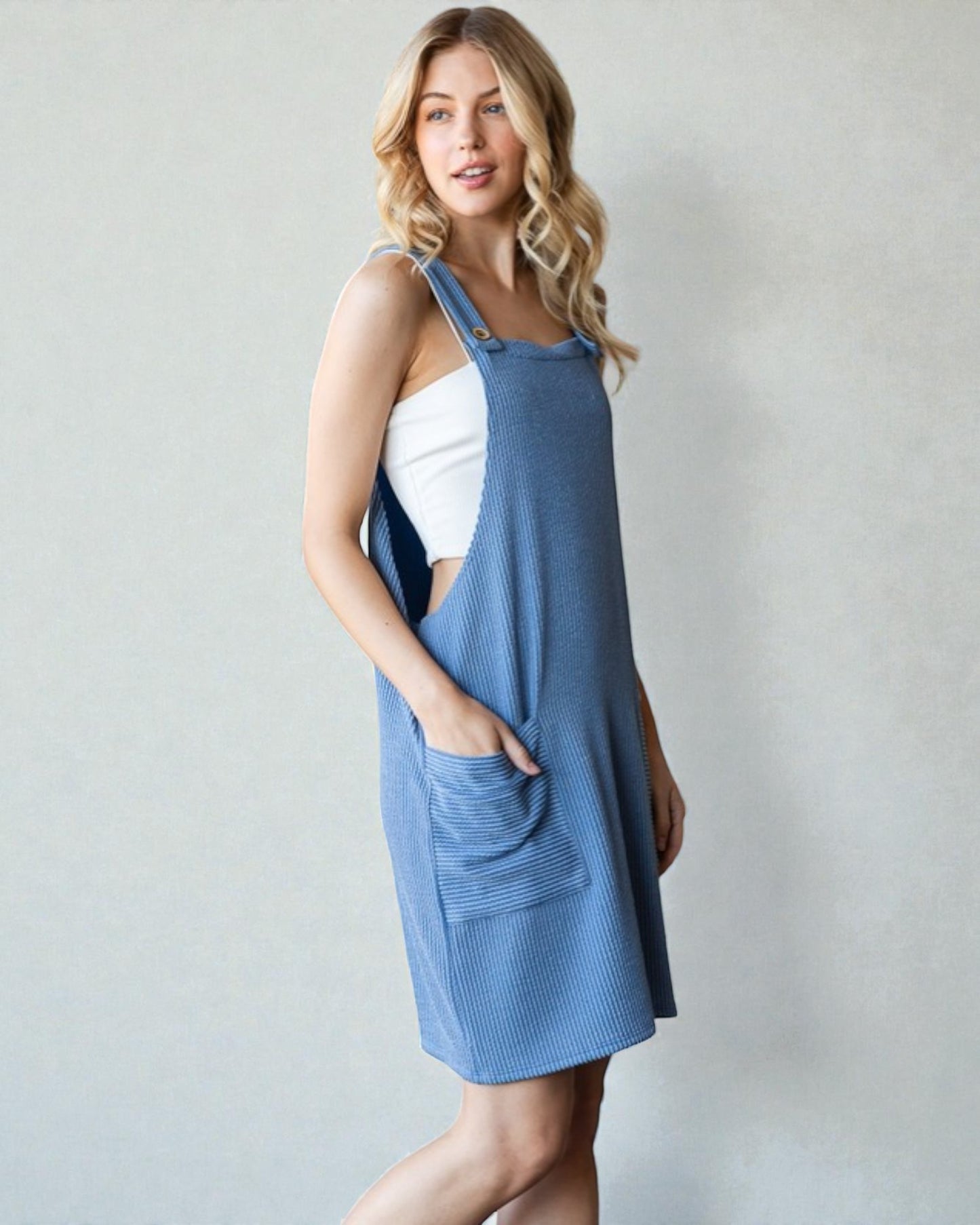 Woman wearing a blue dress with a white background