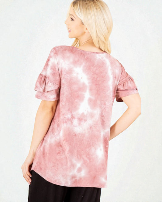Woman wearing a pink tie-dye shirt on a white background