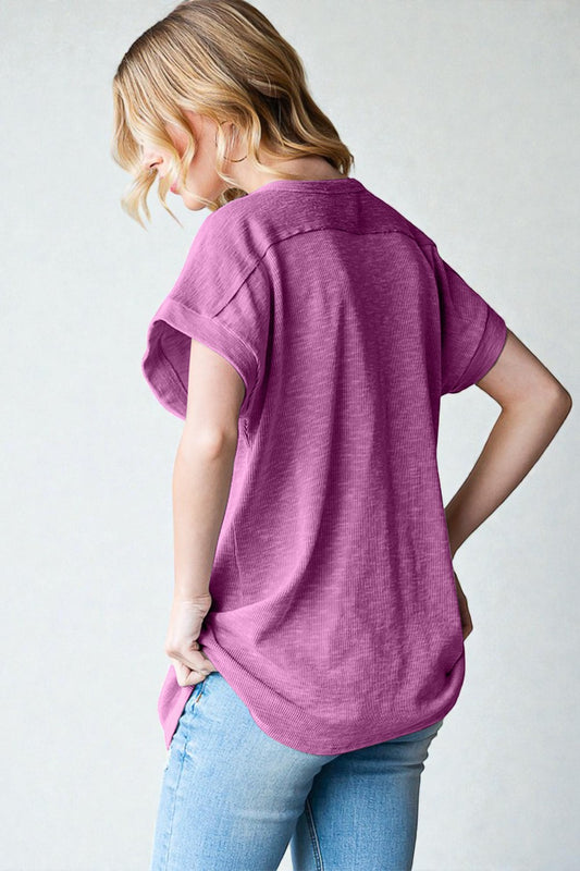 Woman wearing a purple shirt and blue jeans on a white background