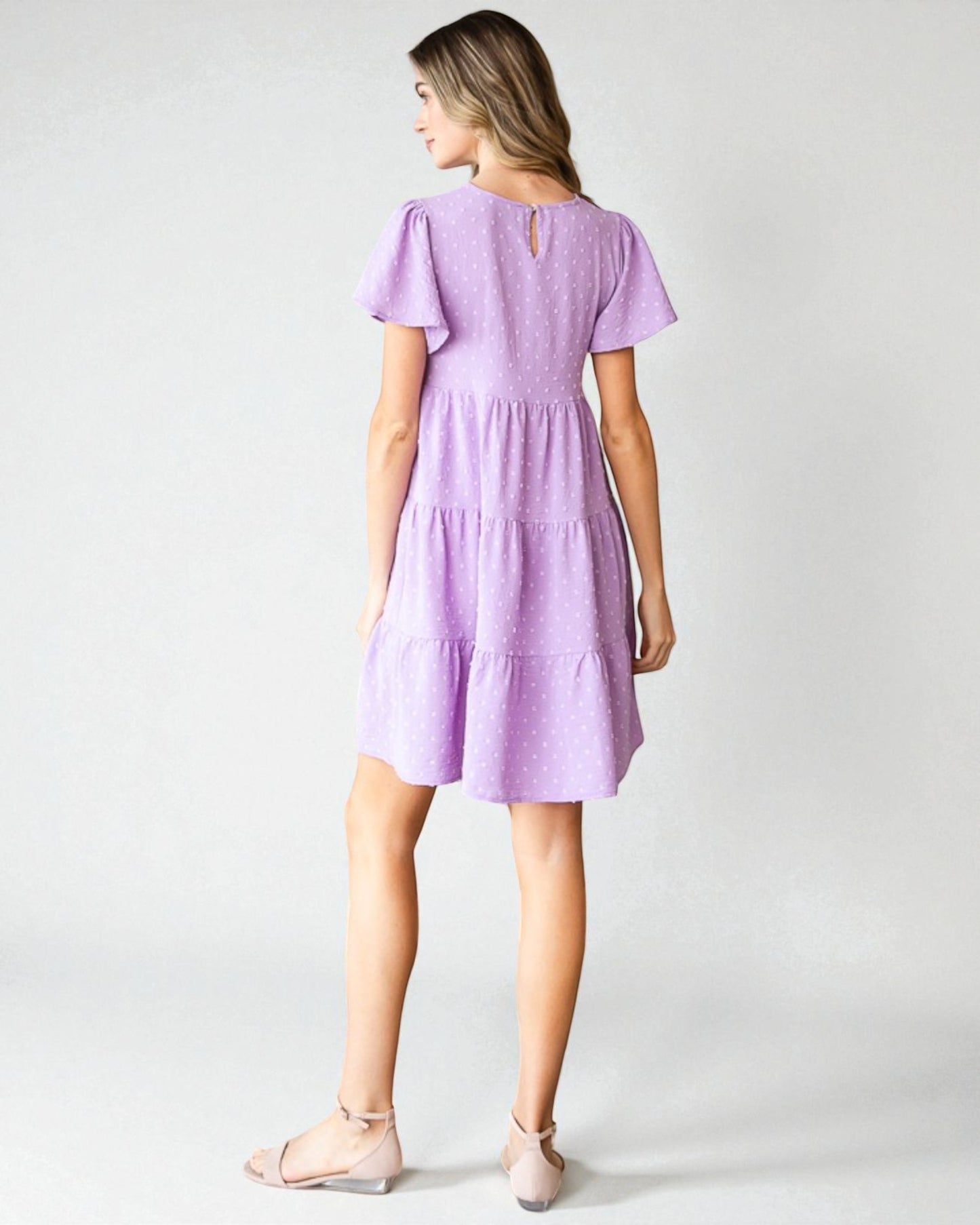 Woman wearing a purple dress on a white background