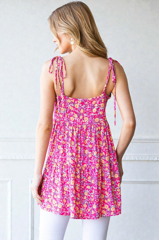 Woman wearing a pink floral dress against a white background