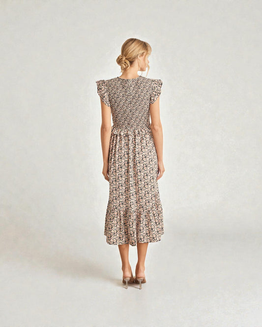 Woman wearing a floral dress on a plain background