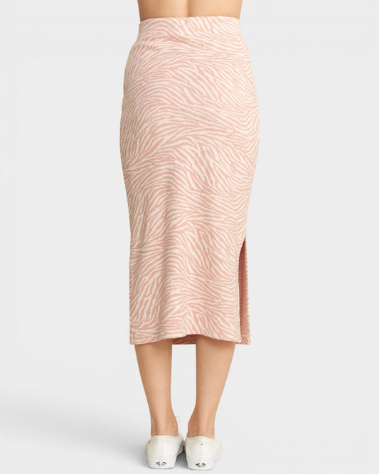 Pink patterned skirt worn by a person on a light gray background