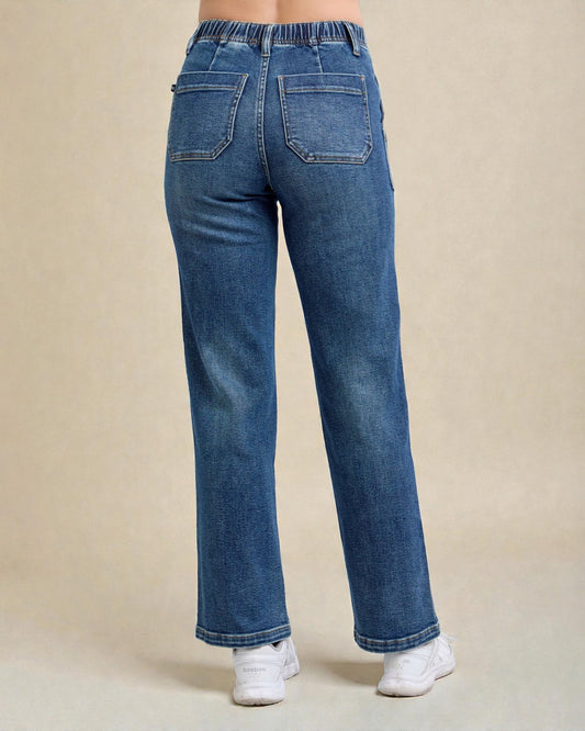 Blue jeans worn by a person on a beige background