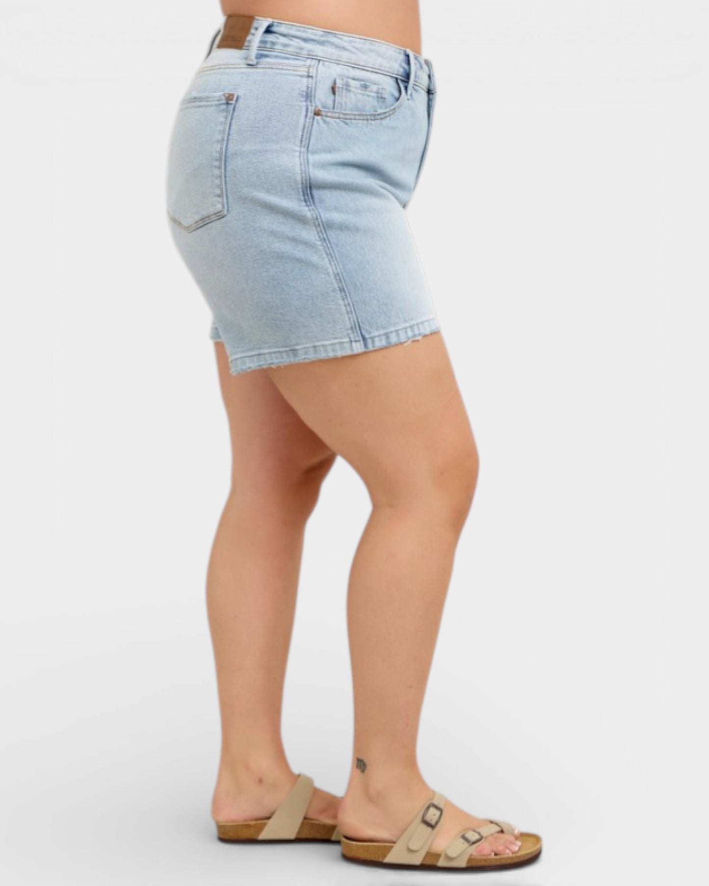Light blue denim skirt worn by a person on a white background