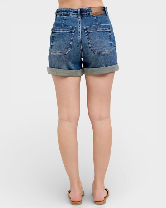 Denim shorts worn by a person on a white background