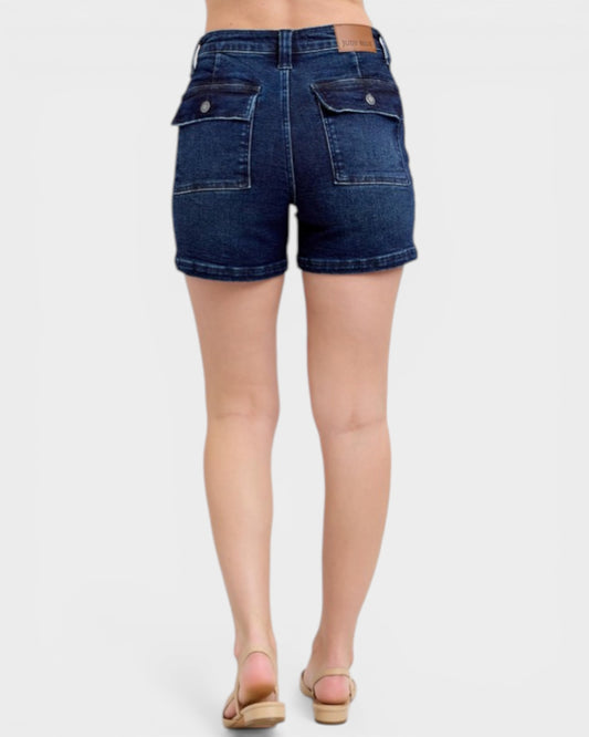 Denim shorts worn by a person on a white background