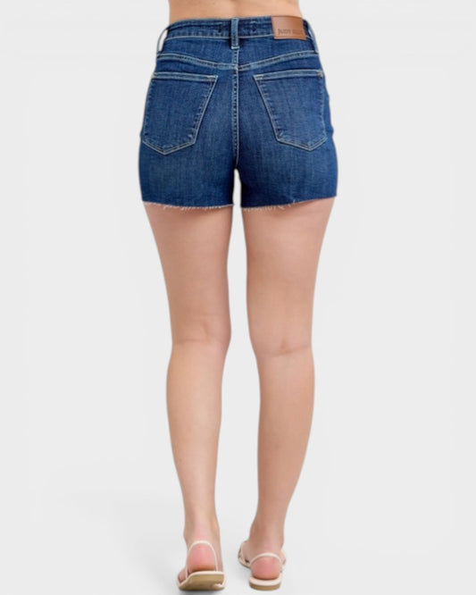 Denim shorts worn by a person on a white background