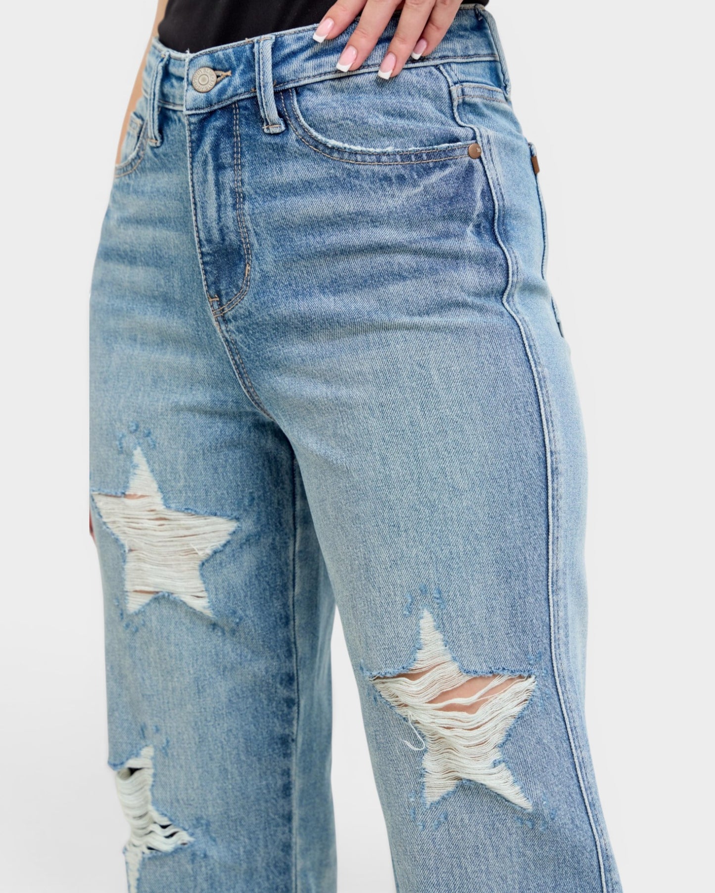Blue jeans with star designs on a white background