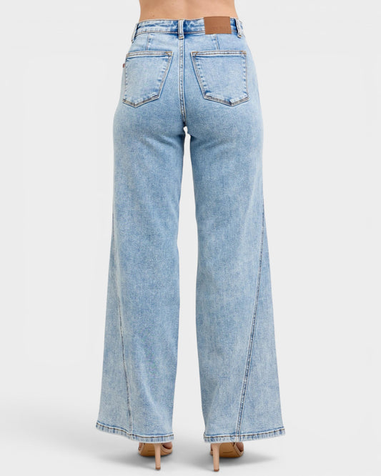 Light blue jeans worn by a person on a white background