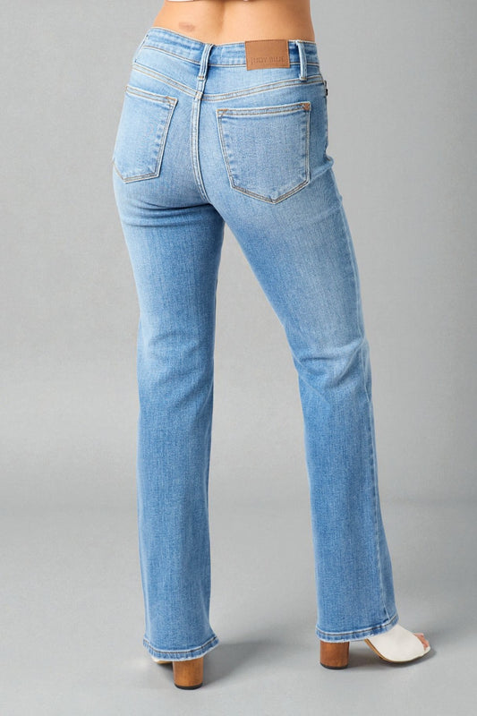 Light blue jeans worn by a person on a gray background