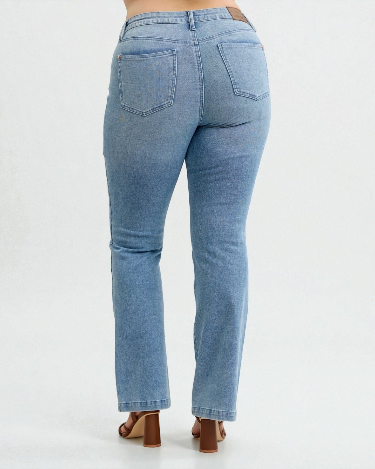 Light blue jeans worn by a person on a white background
