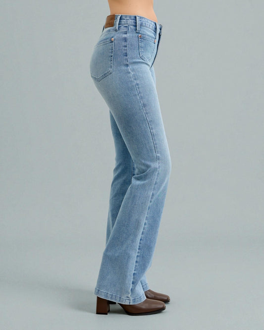 Light blue jeans worn by a person on a gray background
