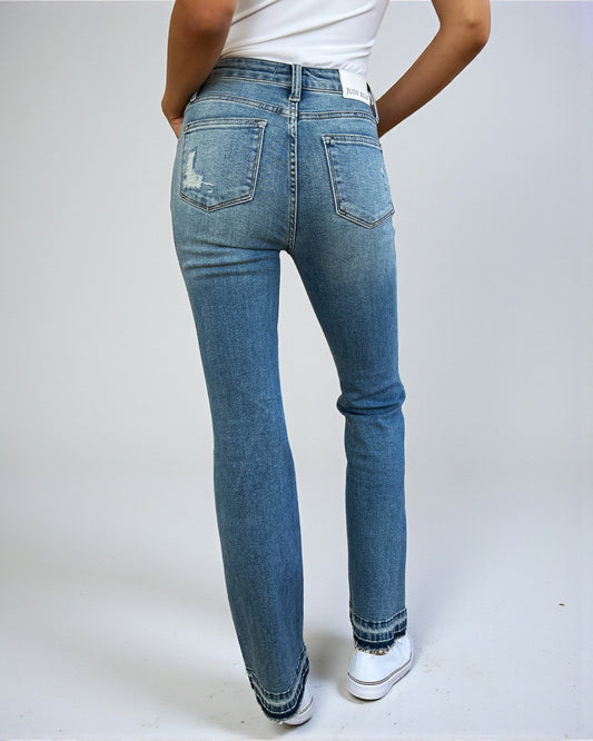 Person wearing blue jeans on a white background