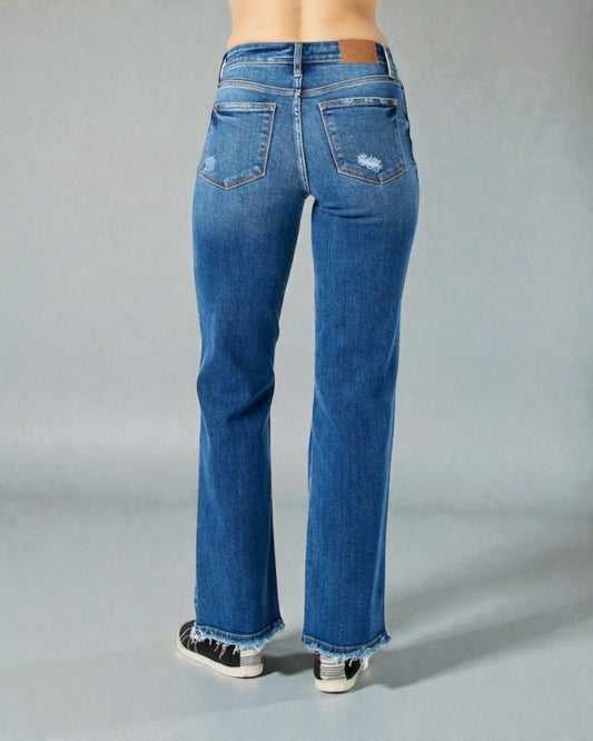 Blue jeans worn by a person on a gray background