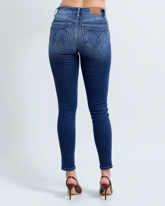 Blue jeans worn by a person on a white background