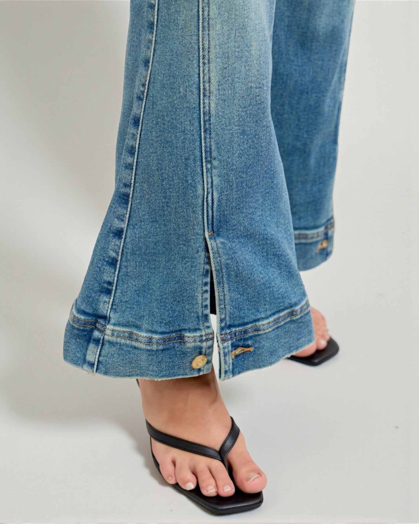 Close-up of blue jeans with a white background