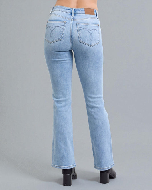 Light blue jeans worn by a person on a gray background