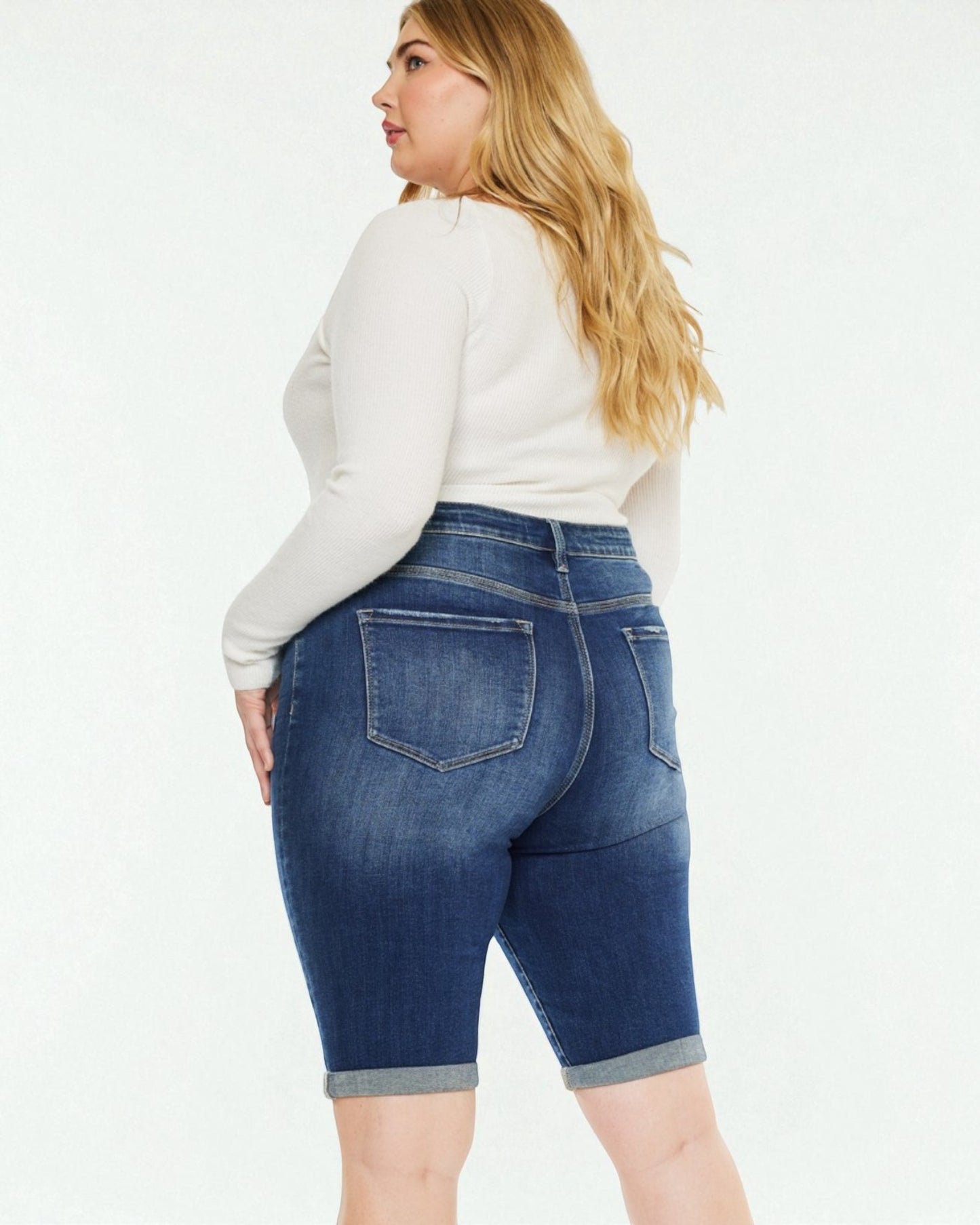 Woman wearing blue denim shorts on a white background