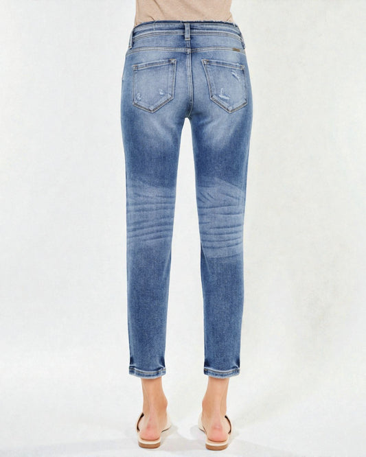 Blue jeans worn by a person on a white background