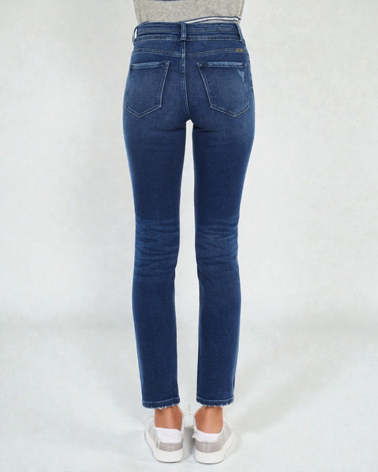 Blue jeans worn by a person on a white background