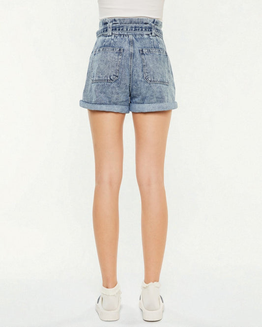 Light blue acid-wash denim shorts worn by a person on a white background