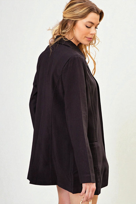 Woman wearing a black jacket on a white background