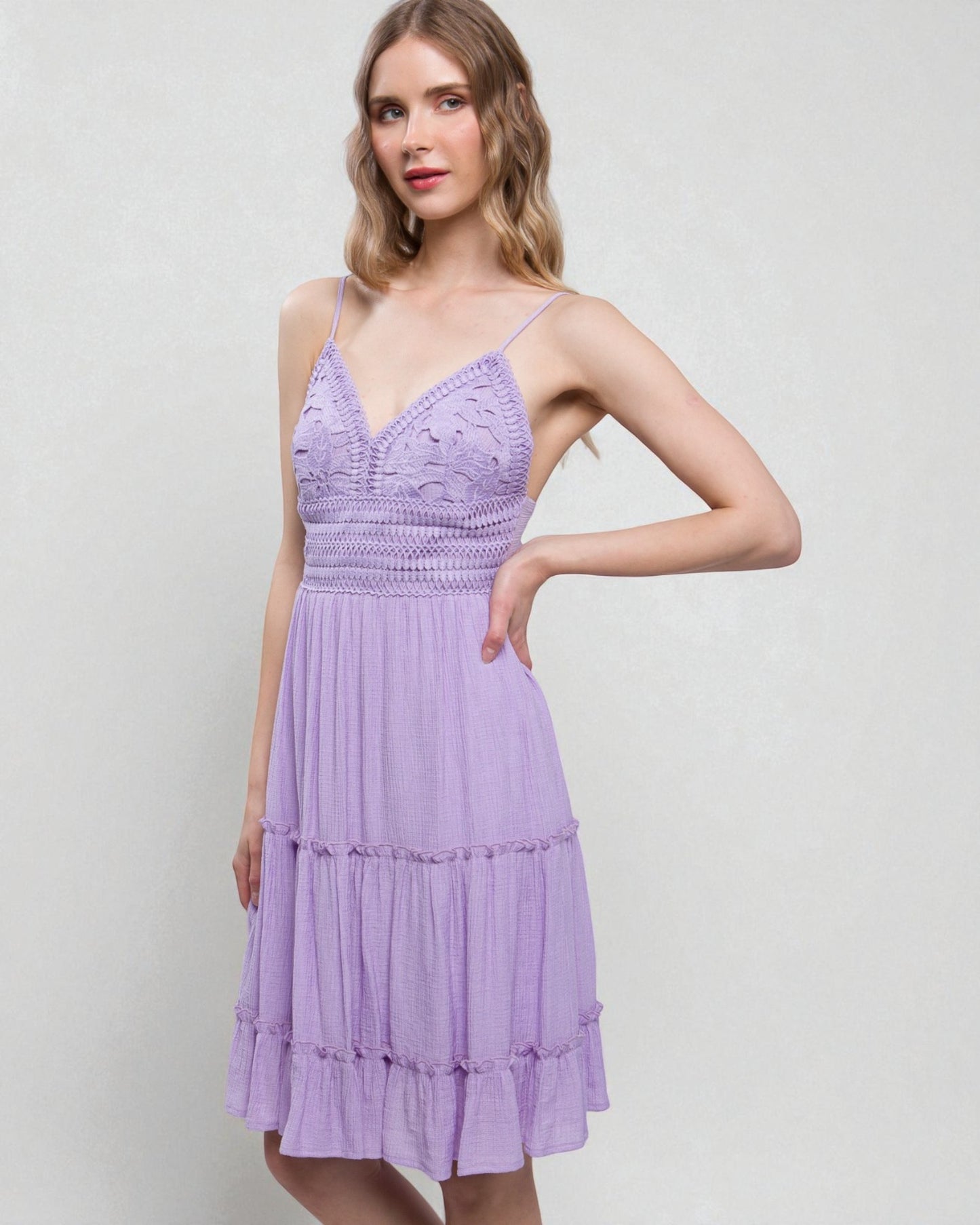 Woman wearing a purple dress against a light gray background